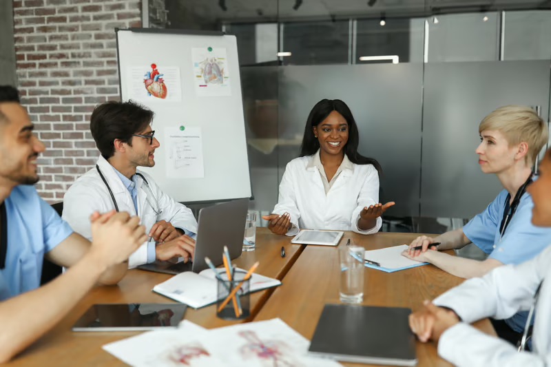 Healthcare leadership team meeting to discuss scaling a business in healthcare through collaboration and strategic planning